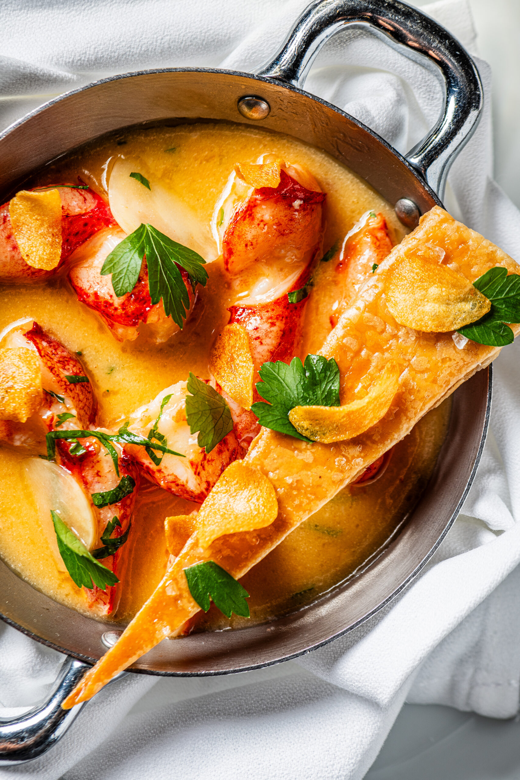 lobster knuckles in garlic butter with lemon, topped by a delicate triangle of pastry crisp